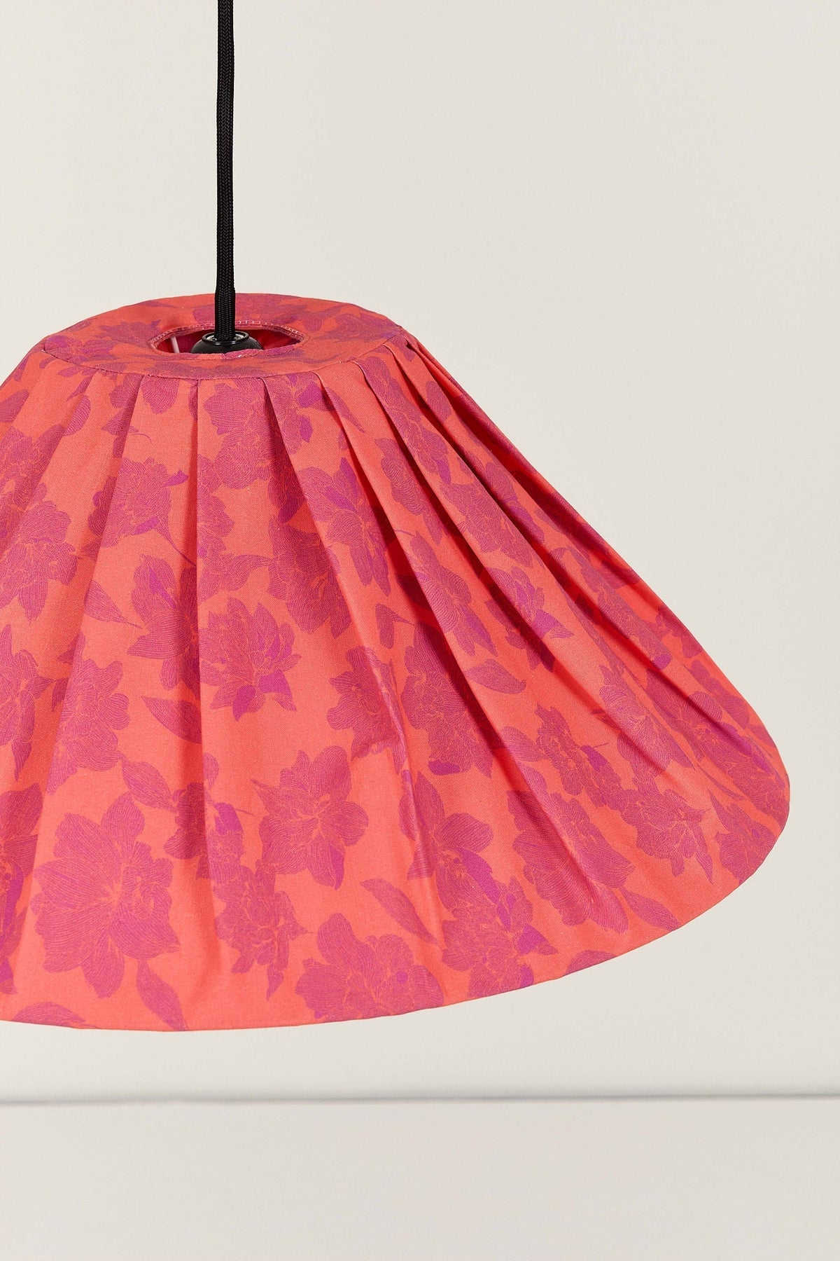 Nobodinoz Ava geplooide lampenkap van 50 cm in rode pioenrozen in een licht, mediterraan ingericht interieur.
